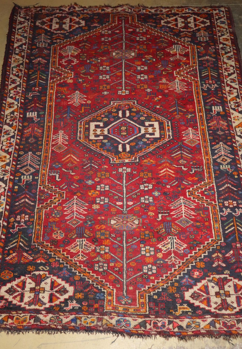 A Caucasian red ground rug, 166 x 116cm